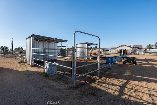 exterior space with an outdoor structure, a rural view, and an exterior structure