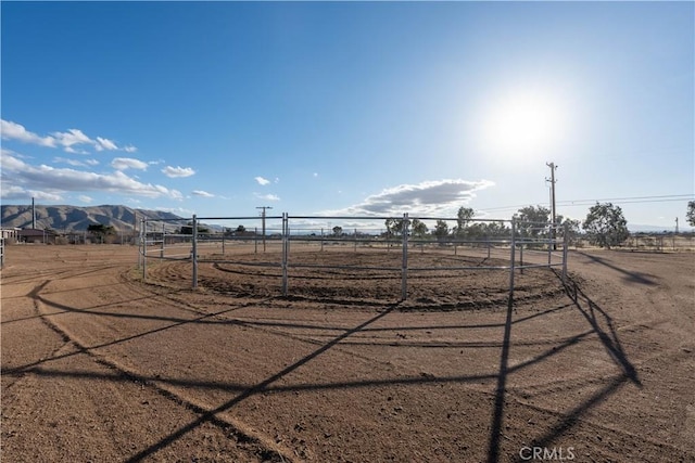 view of yard with a rural view and fence