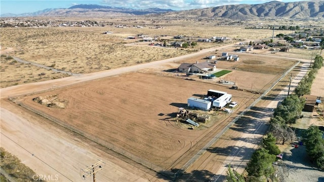 drone / aerial view featuring a desert view, a rural view, and a mountain view