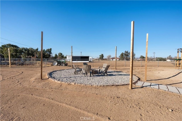 view of yard featuring a fire pit and fence