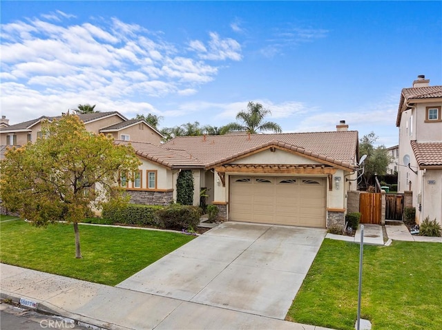 view of front of house with concrete driveway, a tiled roof, a front yard, and stucco siding