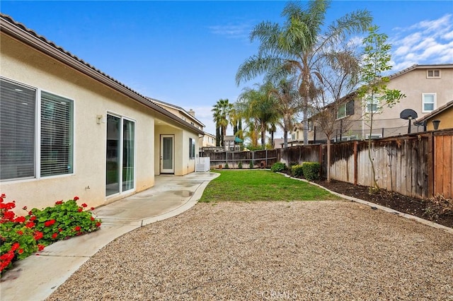 view of yard with a patio and a fenced backyard