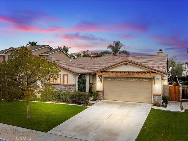 ranch-style home featuring concrete driveway, a front yard, stucco siding, a garage, and stone siding