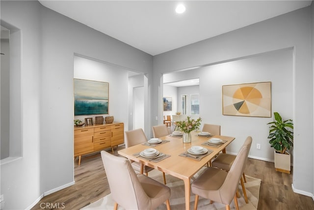 dining room featuring baseboards and wood finished floors