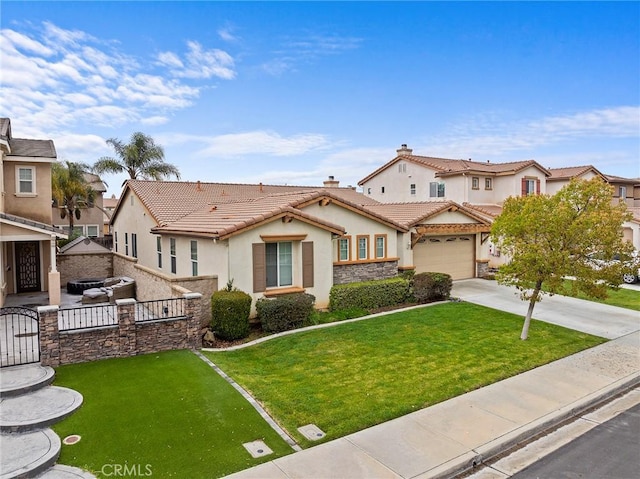 view of front facade with fence, a tile roof, concrete driveway, a front yard, and stucco siding