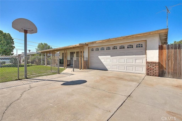 ranch-style home with a gate, concrete driveway, a front lawn, and fence