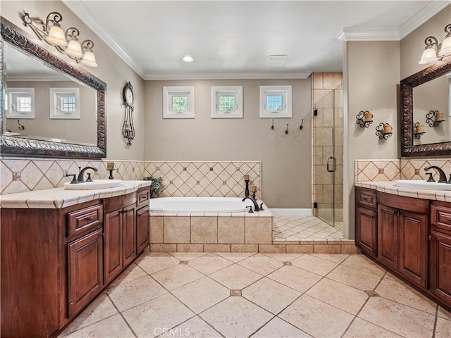 full bath featuring a sink, a stall shower, crown molding, and tile patterned flooring