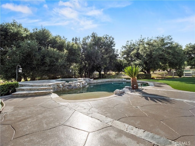 view of swimming pool featuring a patio area and a pool with connected hot tub