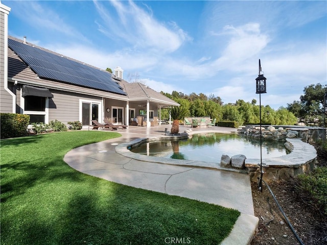 pool featuring a patio and a lawn