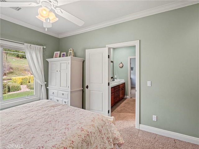 unfurnished bedroom featuring crown molding, ceiling fan, baseboards, light colored carpet, and a sink