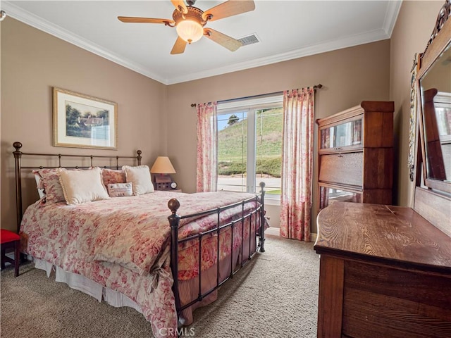 bedroom with visible vents, light colored carpet, crown molding, and ceiling fan