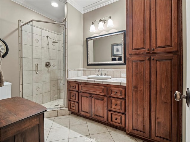 full bathroom featuring vanity, ornamental molding, a shower stall, and tile patterned flooring