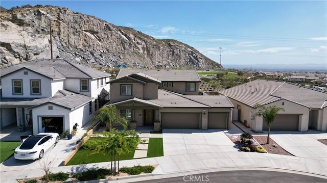 6594 June Mountain Way, Jurupa Valley, CA 92509 - view of front of home featuring a garage, concrete driveway, stucco siding, and a tile roof