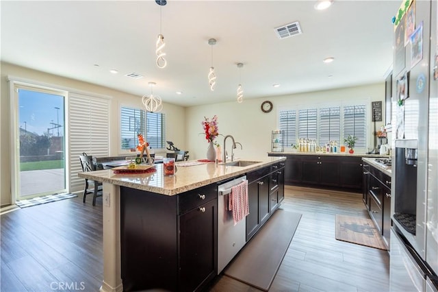 6594 June Mountain Way, Jurupa Valley, CA 92509 - kitchen with visible vents, a sink, light stone counters, wood finished floors, and dishwasher