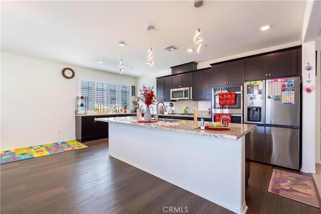 6594 June Mountain Way, Jurupa Valley, CA 92509 - kitchen featuring visible vents, dark wood-type flooring, pendant lighting, light stone counters, and appliances with stainless steel finishes
