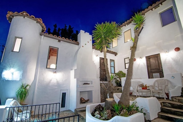 interior space with a tiled roof and stucco siding