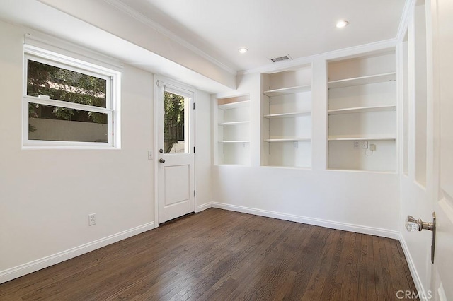 interior space featuring visible vents, dark wood-type flooring, baseboards, ornamental molding, and recessed lighting