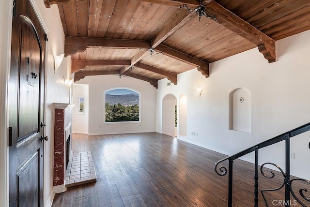interior space with vaulted ceiling with beams, baseboards, wood ceiling, arched walkways, and wood-type flooring