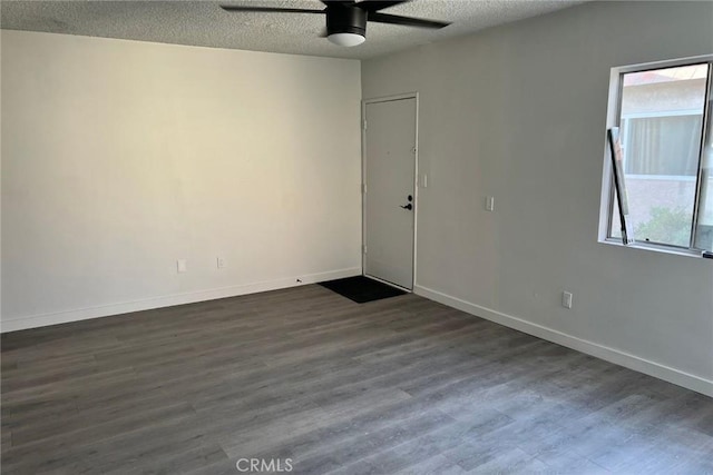 empty room with dark wood-style floors, a textured ceiling, and ceiling fan
