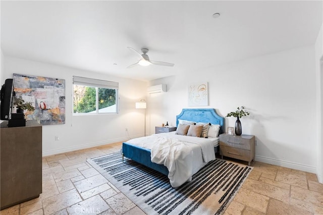 bedroom with stone tile flooring, a ceiling fan, a wall mounted AC, and baseboards
