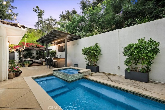 view of pool featuring an outdoor living space, a patio, area for grilling, and a pool with connected hot tub