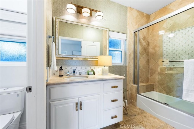 full bath with vanity, toilet, shower / bath combination with glass door, and tile patterned flooring