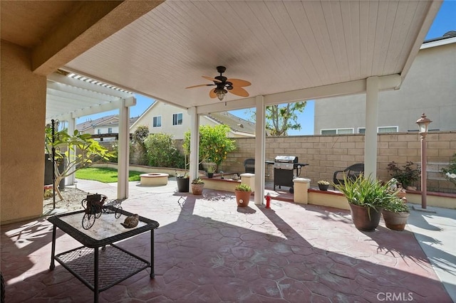 view of patio / terrace featuring grilling area, a fire pit, a pergola, and fence