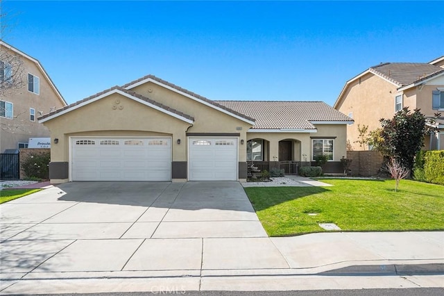 view of front of property featuring a front yard, driveway, stucco siding, a garage, and a tile roof