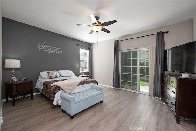 bedroom with access to exterior, light wood-style flooring, a ceiling fan, and baseboards