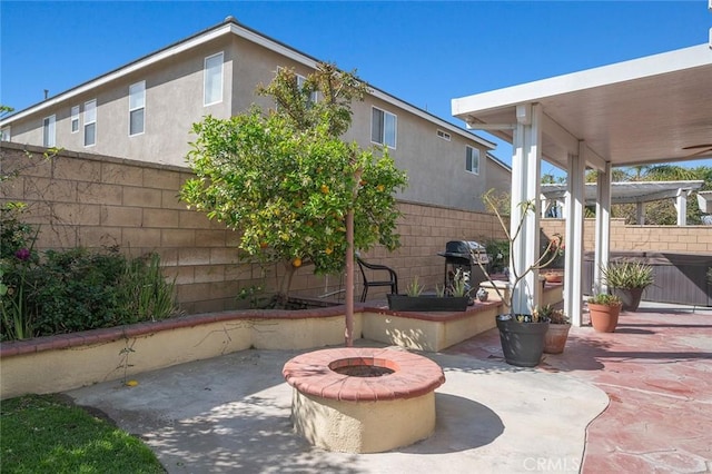 view of patio with grilling area, an outdoor fire pit, and fence