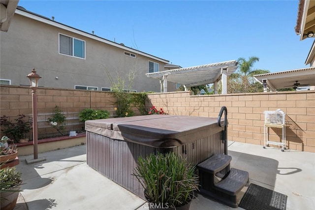 view of patio / terrace featuring a pergola, a hot tub, and fence