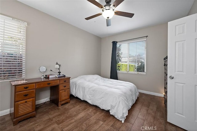 bedroom featuring a ceiling fan, baseboards, and dark wood-style flooring