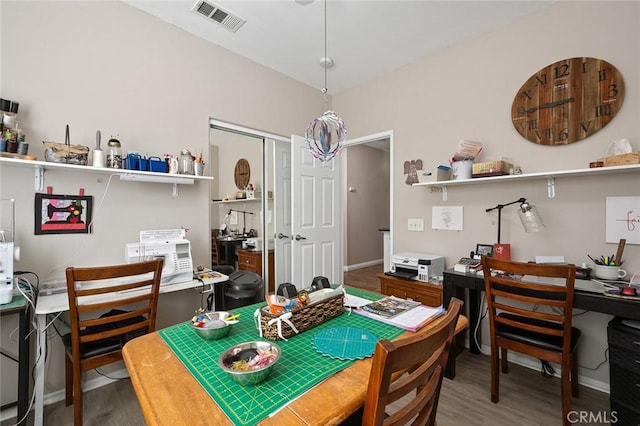 dining area featuring visible vents, baseboards, and wood finished floors