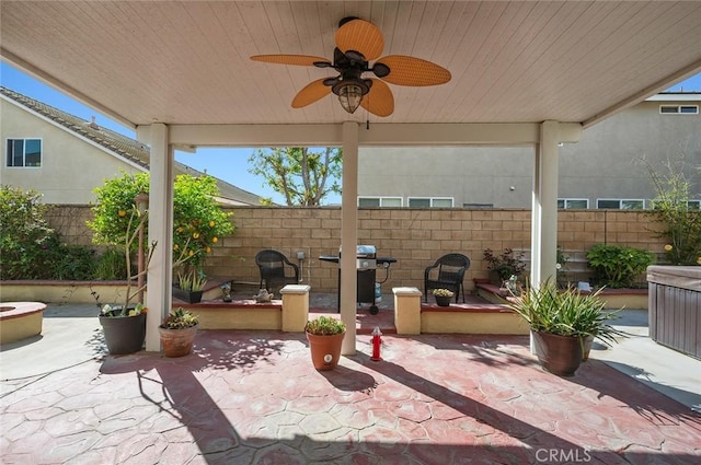 view of patio with grilling area, a ceiling fan, and fence