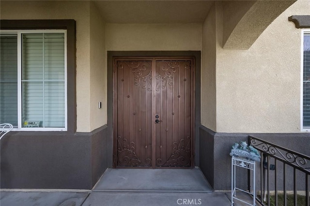 property entrance with stucco siding