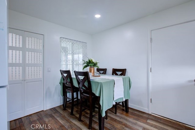 dining area featuring recessed lighting, wood finished floors, and baseboards