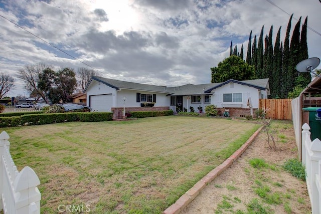 single story home featuring an attached garage, a front lawn, and fence