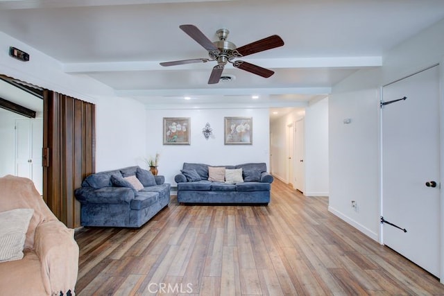 living room with light wood-type flooring, beamed ceiling, baseboards, and a ceiling fan