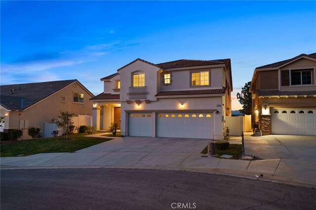 traditional-style home with a garage, a tile roof, concrete driveway, and stucco siding