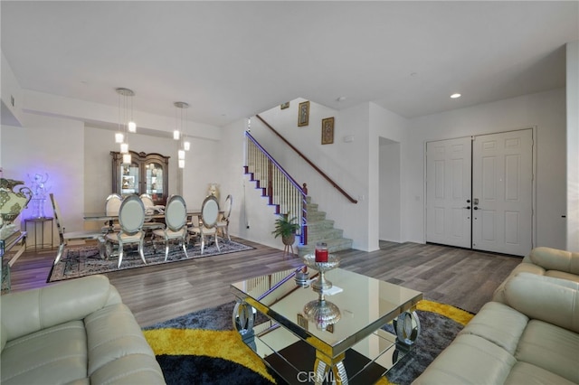 living area with stairway, recessed lighting, and wood finished floors