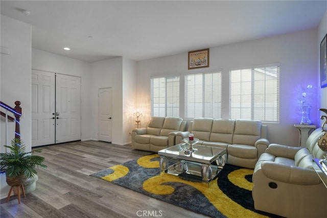 living room with recessed lighting, baseboards, and wood finished floors