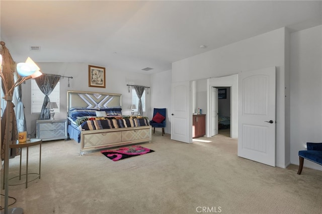 carpeted bedroom featuring visible vents