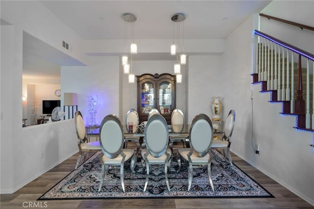 dining space featuring visible vents, baseboards, and wood finished floors