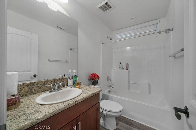 full bathroom featuring bathtub / shower combination, toilet, vanity, and visible vents