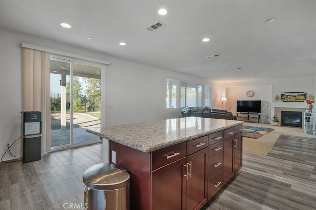 kitchen with recessed lighting, a healthy amount of sunlight, visible vents, and a kitchen island