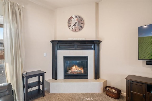 room details with a tiled fireplace and carpet