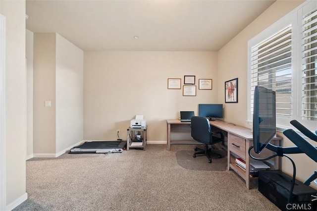 home office featuring baseboards and carpet