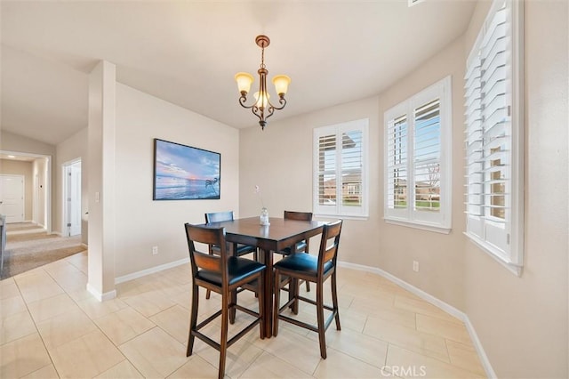 dining area with light tile patterned floors, a notable chandelier, and baseboards