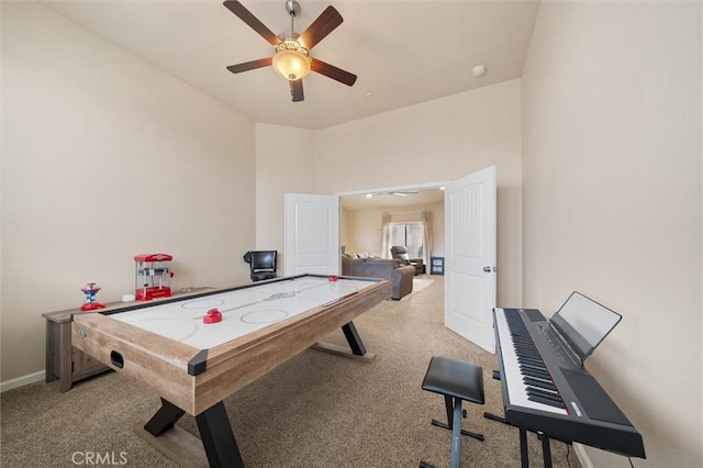 recreation room featuring a ceiling fan, carpet, and baseboards