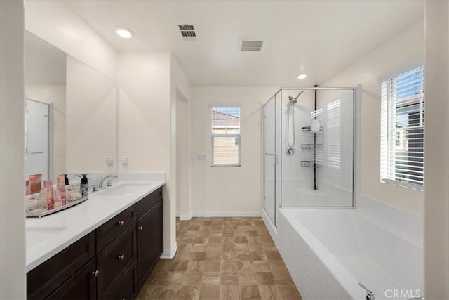 full bathroom featuring visible vents, double vanity, a sink, a shower stall, and a bath